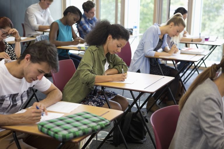 university students taking exam in classroom 530682783 58a1e1a13df78c4758534e6a